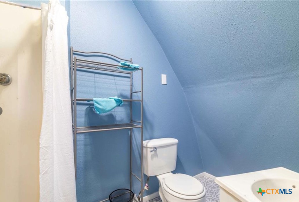 503 Rabbit Run Road Victoria, TX 77905 - Photo 19 of 20 a white toilet sitting next to a shower curtain