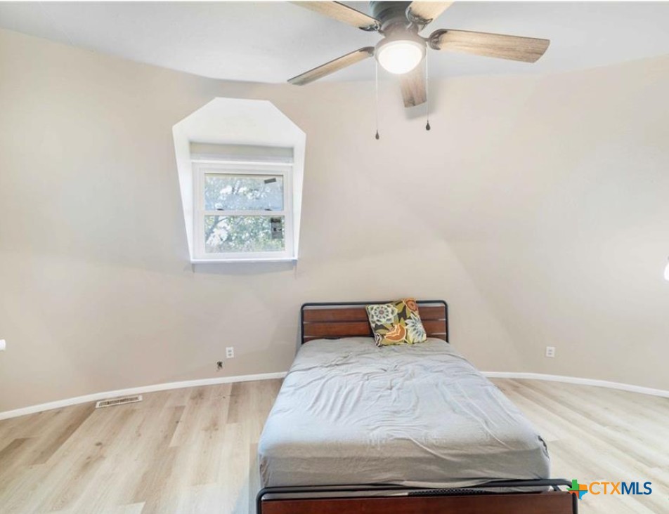 503 Rabbit Run Road Victoria, TX 77905 - Photo 10 of 20 a bedroom with a bed and a chandelier