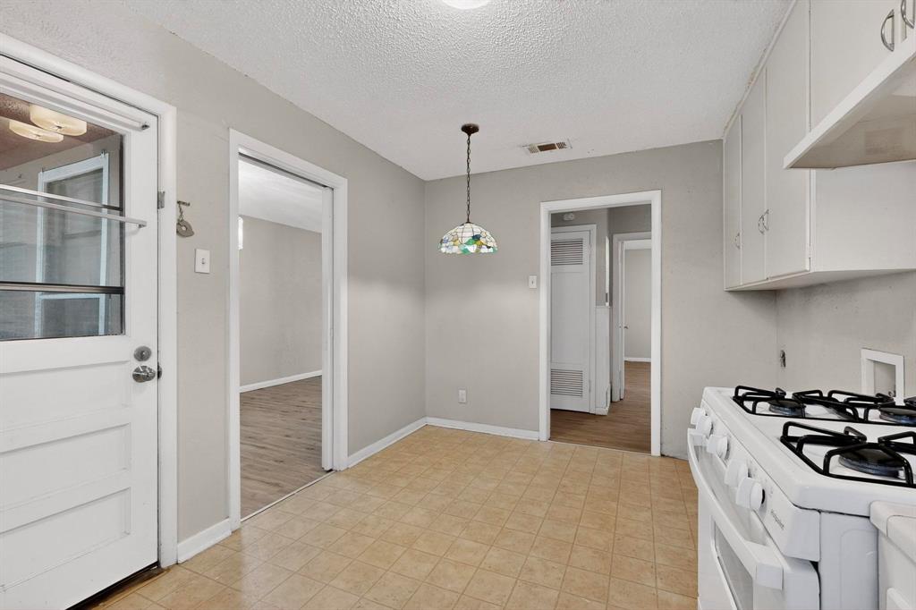 4508 Rutland Avenue Fort Worth, TX 76133 - Photo 16 of 36 a kitchen that has a stove and a refrigerator