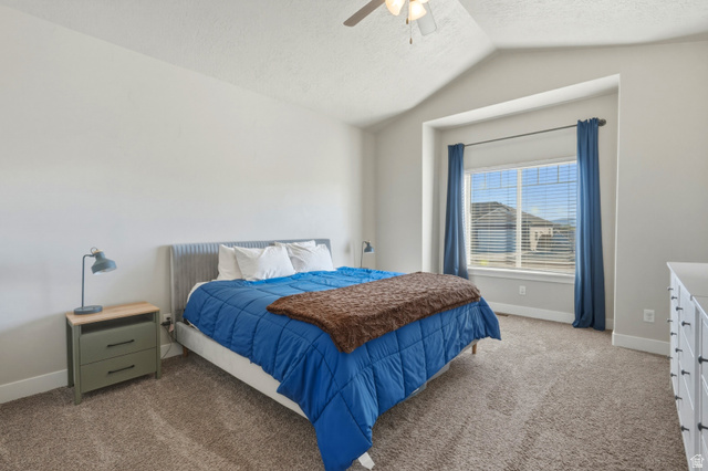 836 South 250 West Vernal, UT 84078 - Photo 9 of 56 Bedroom with light colored carpet, a ceiling fan, and a textured ceiling