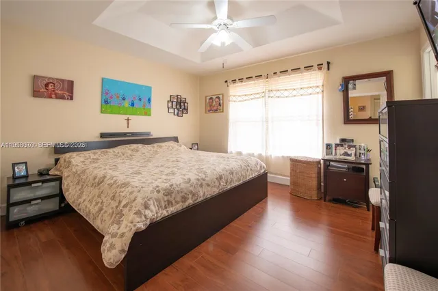 a spacious bedroom with a bed and a window