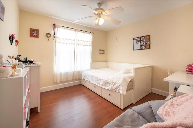 a spacious bedroom with a bed and a window