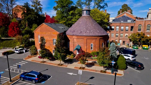 a view of a street with potted plants