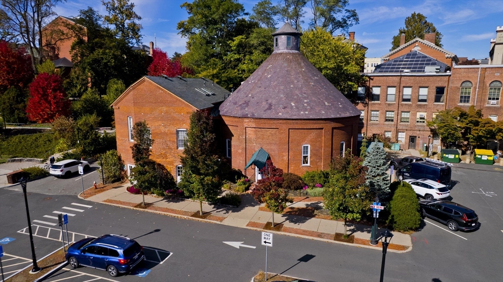 a view of a street with potted plants