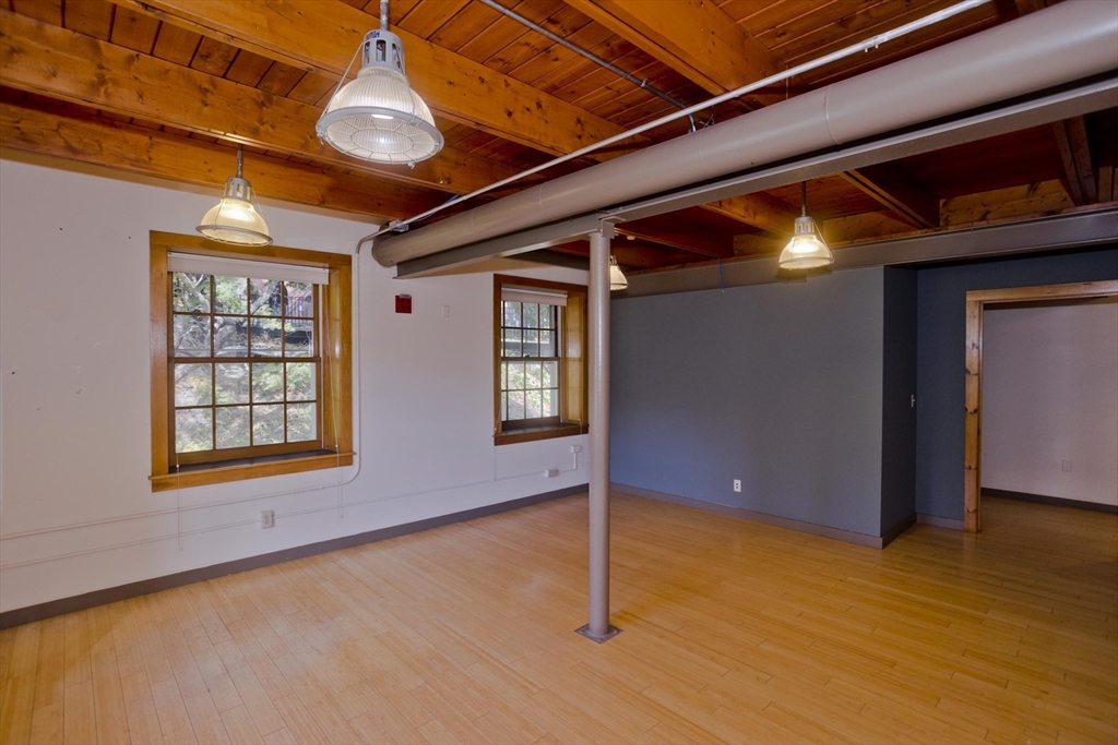 244 Main Street Northampton, MA 01060 - Photo 11 of 28 a view of an empty room with windows