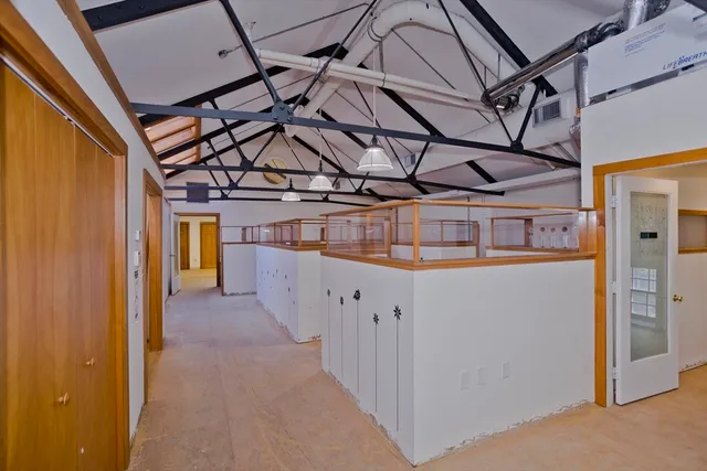 a view of a livingroom with wooden floor and a window