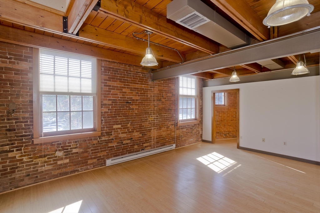 244 Main Street Northampton, MA 01060 - Photo 17 of 28 a view of a livingroom with wooden floor and a window