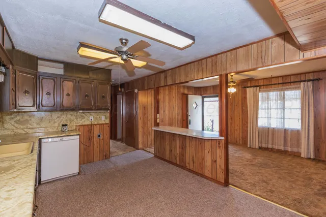 a bathroom with a sink a toilet and shower curtain