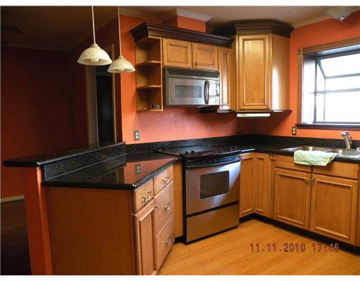 7201 Rugged Ridge Drive Corpus Christi, TX 78413 - Photo 2 of 4 a kitchen with stainless steel appliances granite countertop a sink a stove and a refrigerator