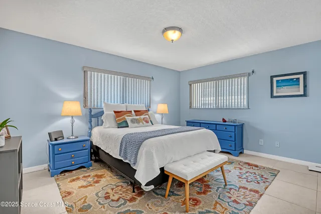 a bedroom with furniture and a rug