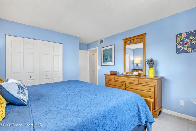 a bedroom with a bed and a dresser in it