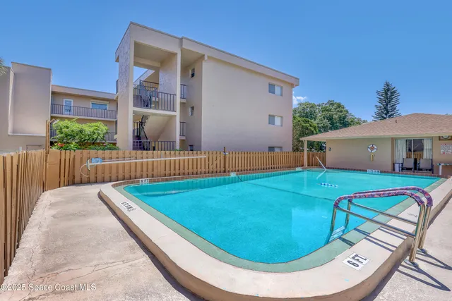 a view of backyard with swimming pool and porch