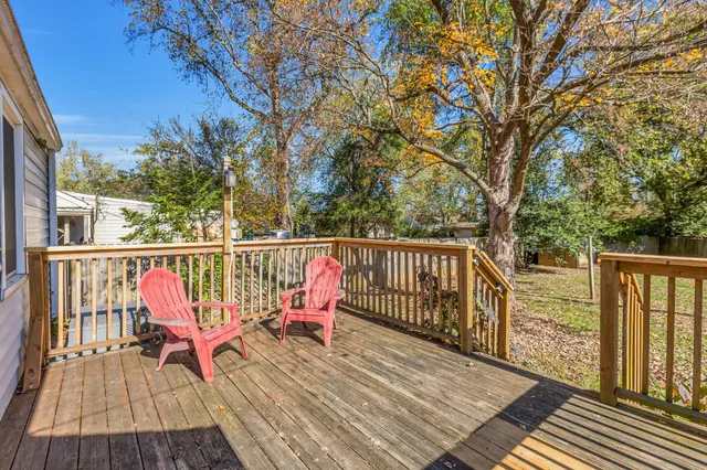 a view of balcony with wooden floor and fence