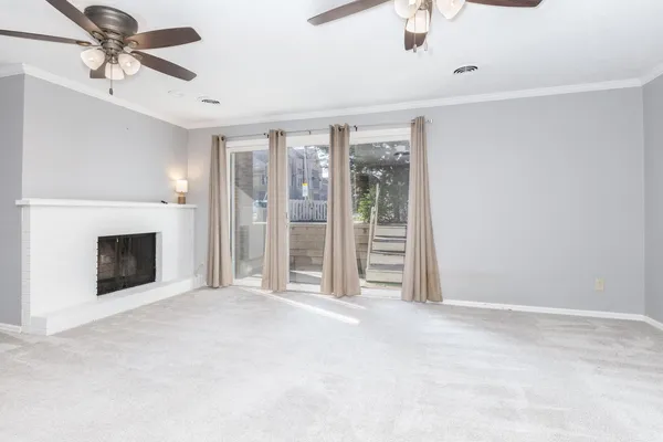 a view of a livingroom with an empty space and a fireplace