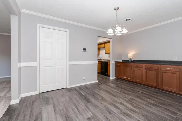 a view of a kitchen with wooden floor and kitchen