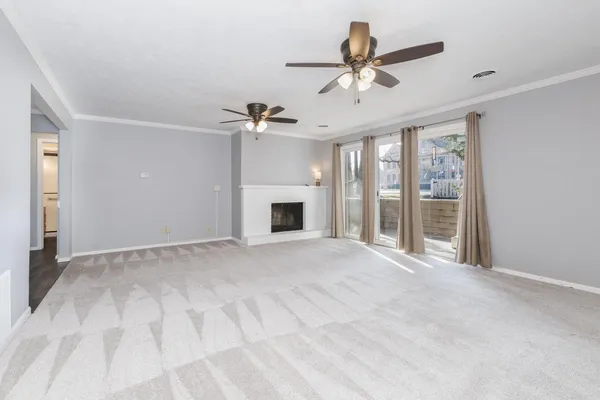 a view of an empty room with a fireplace