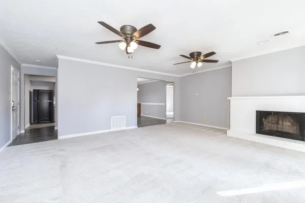 a view of an empty room with a fireplace