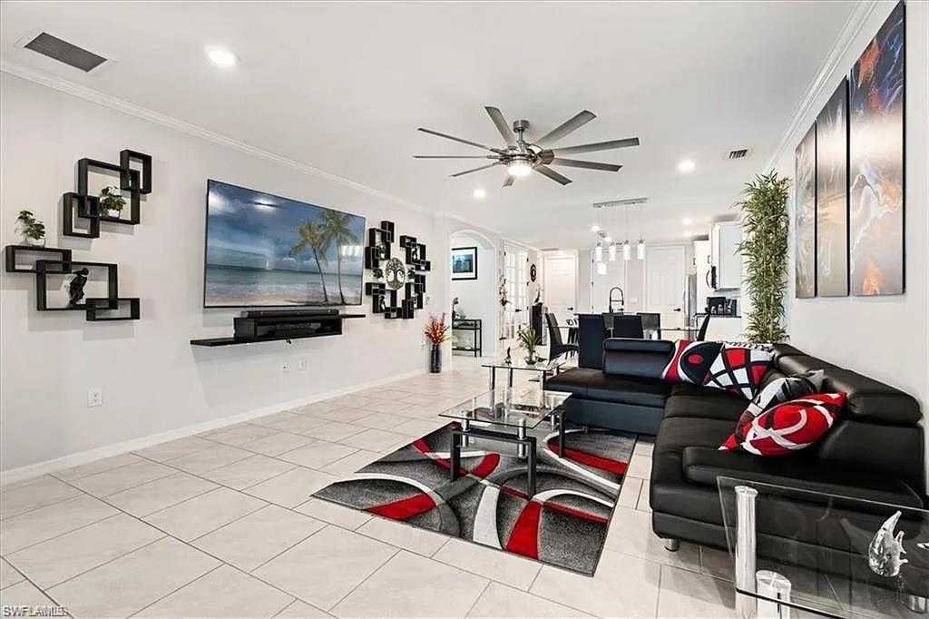 14672 Edgewater Circle Naples, FL 34114 - Photo 3 of 41 a living room with furniture and a flat screen tv