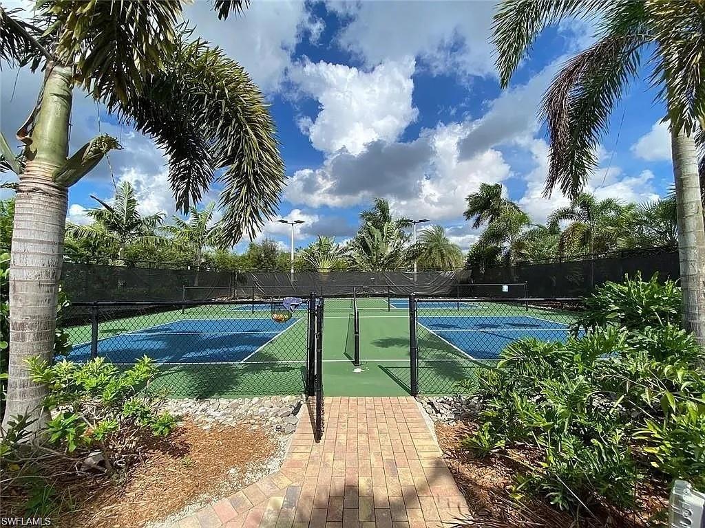 14672 Edgewater Circle Naples, FL 34114 - Photo 32 of 41 a view of a yard with flower plants