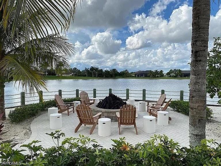 14672 Edgewater Circle Naples, FL 34114 - Photo 38 of 41 a swimming pool with outdoor seating and lake view