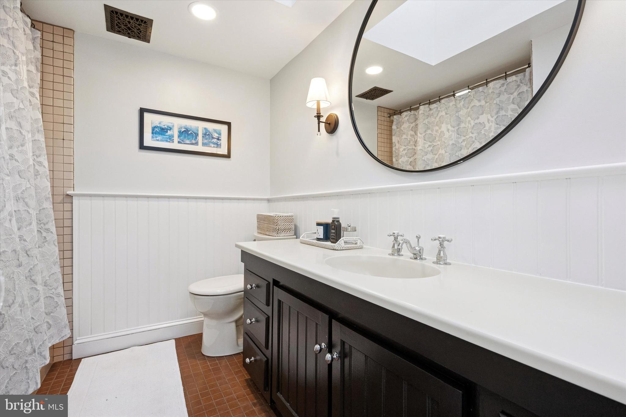 315 Fitzwater Street Philadelphia, PA 19147 - Photo 26 of 32 a bathroom with a sink a toilet and a mirror