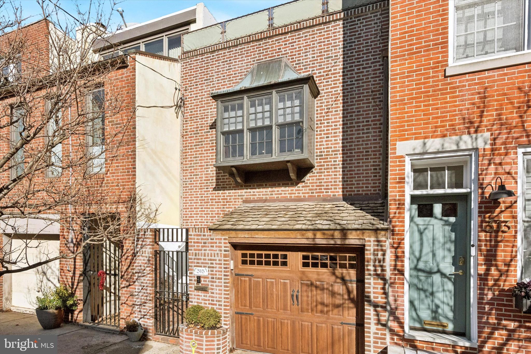 315 Fitzwater Street Philadelphia, PA 19147 - Photo 4 of 32 a brick building with a door and a window
