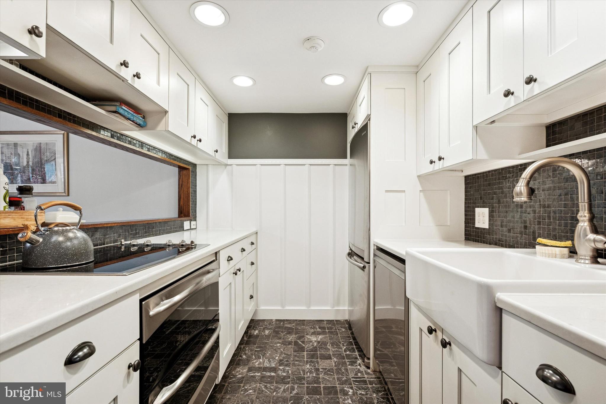 315 Fitzwater Street Philadelphia, PA 19147 - Photo 7 of 32 a kitchen with stainless steel appliances a sink stove and cabinets