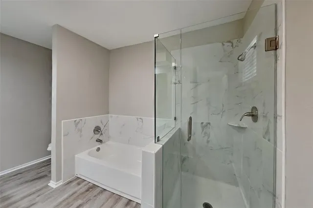 a bathroom with a bathtub and a shower