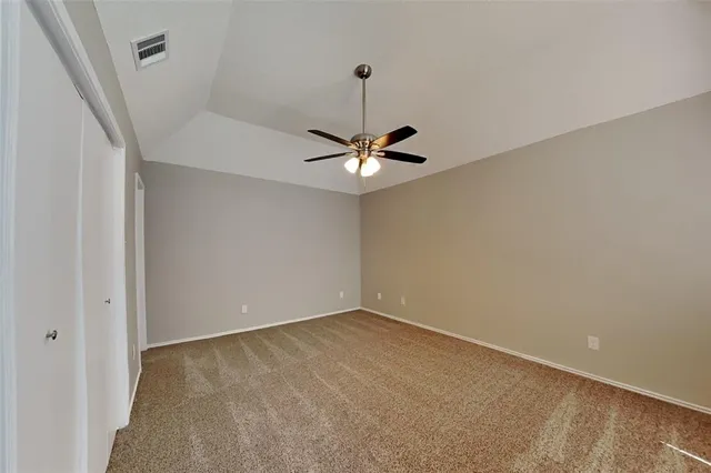 a view of a room with a ceiling fan