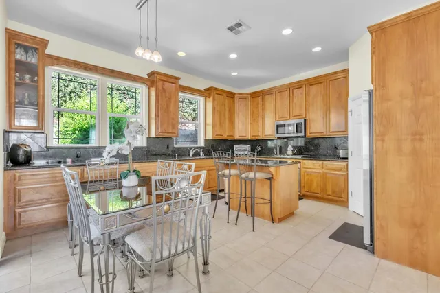 a kitchen with counter top space a sink appliances and cabinets