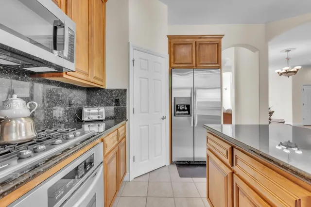 a kitchen with stainless steel appliances granite countertop a sink and a stove