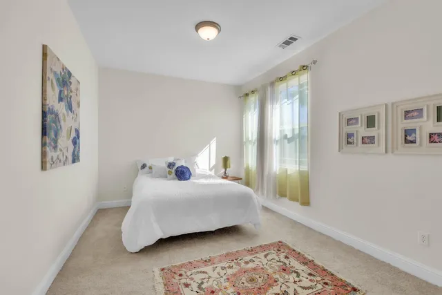 a bedroom with a bed and glass window