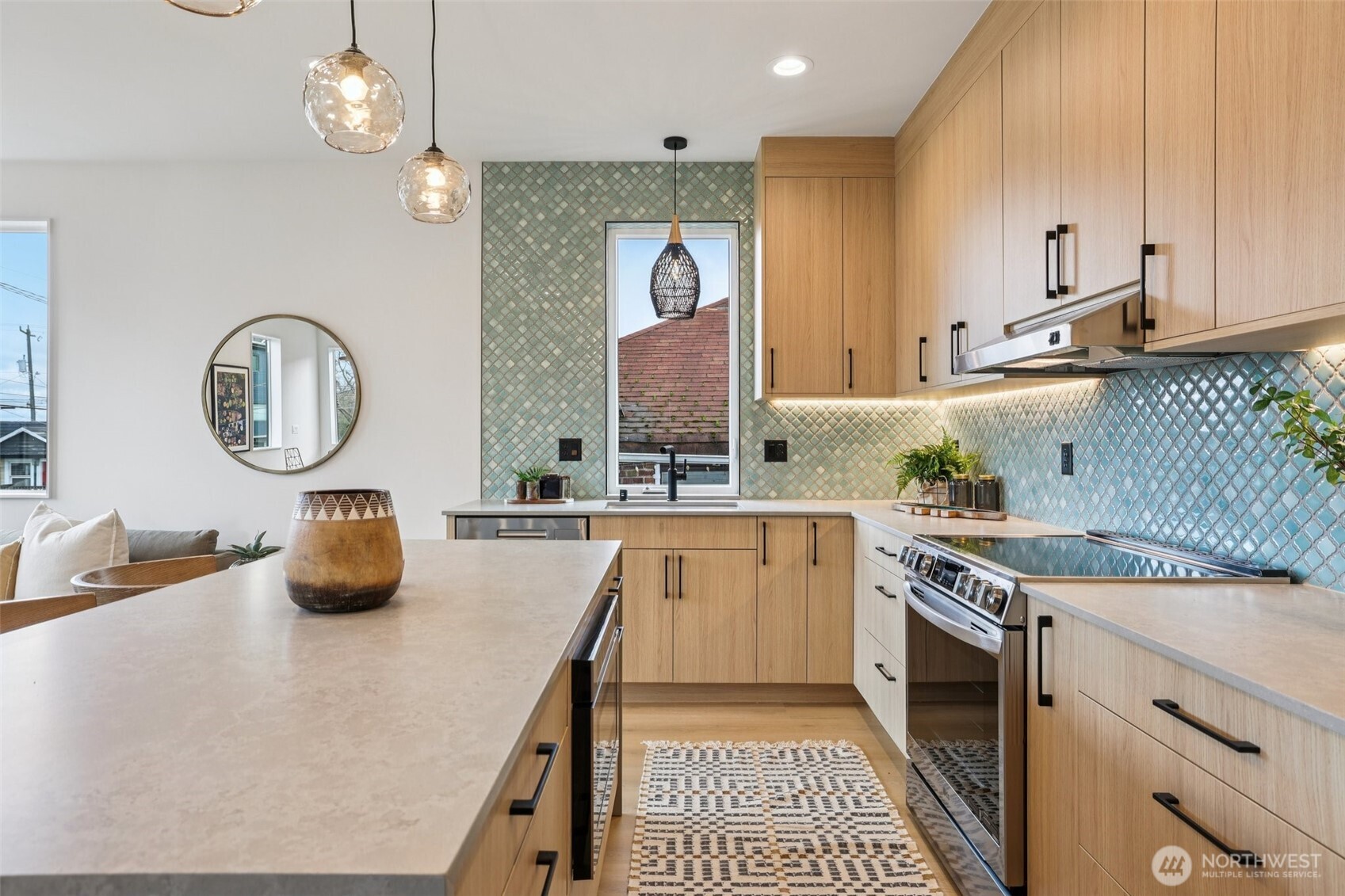 2628 58th Avenue Southwest Seattle, WA 98116 - Photo 12 of 38 a kitchen with a sink dishwasher a stove and white cabinets with wooden floor
