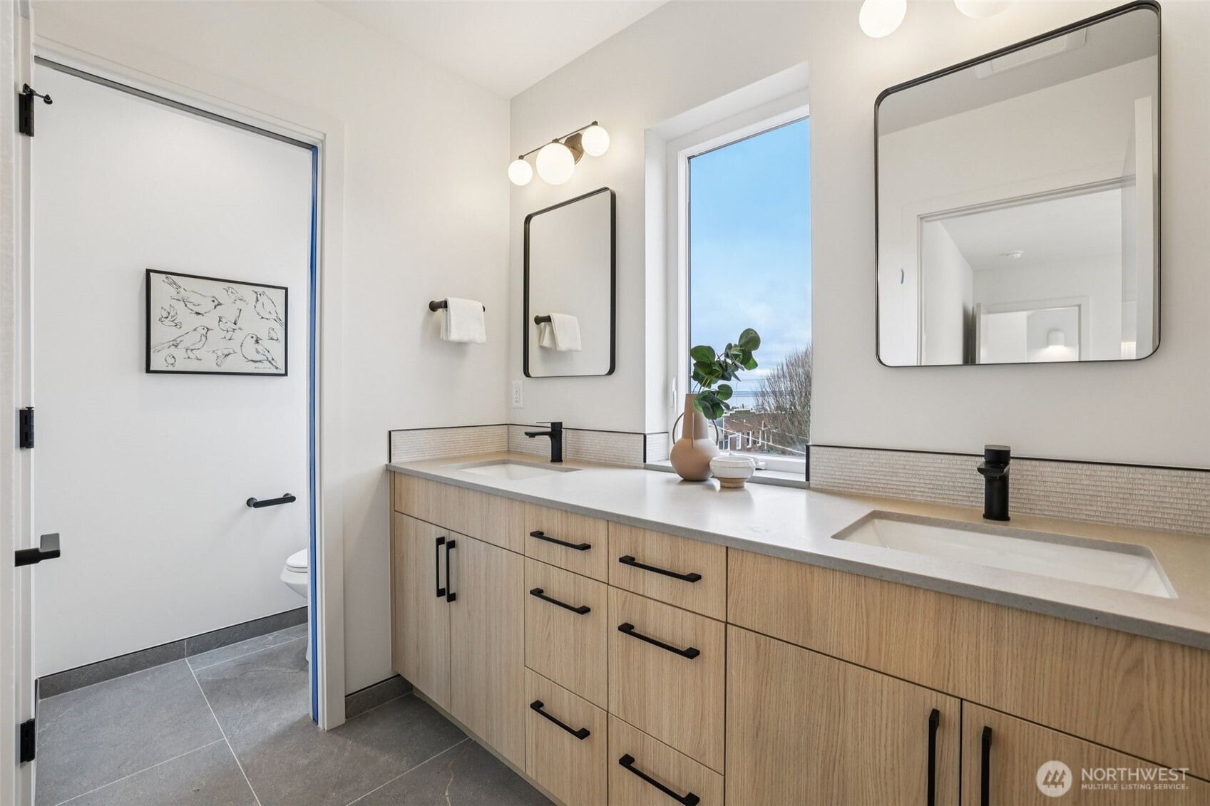 2628 58th Avenue Southwest Seattle, WA 98116 - Photo 20 of 38 a bathroom with a double vanity sink and a mirror