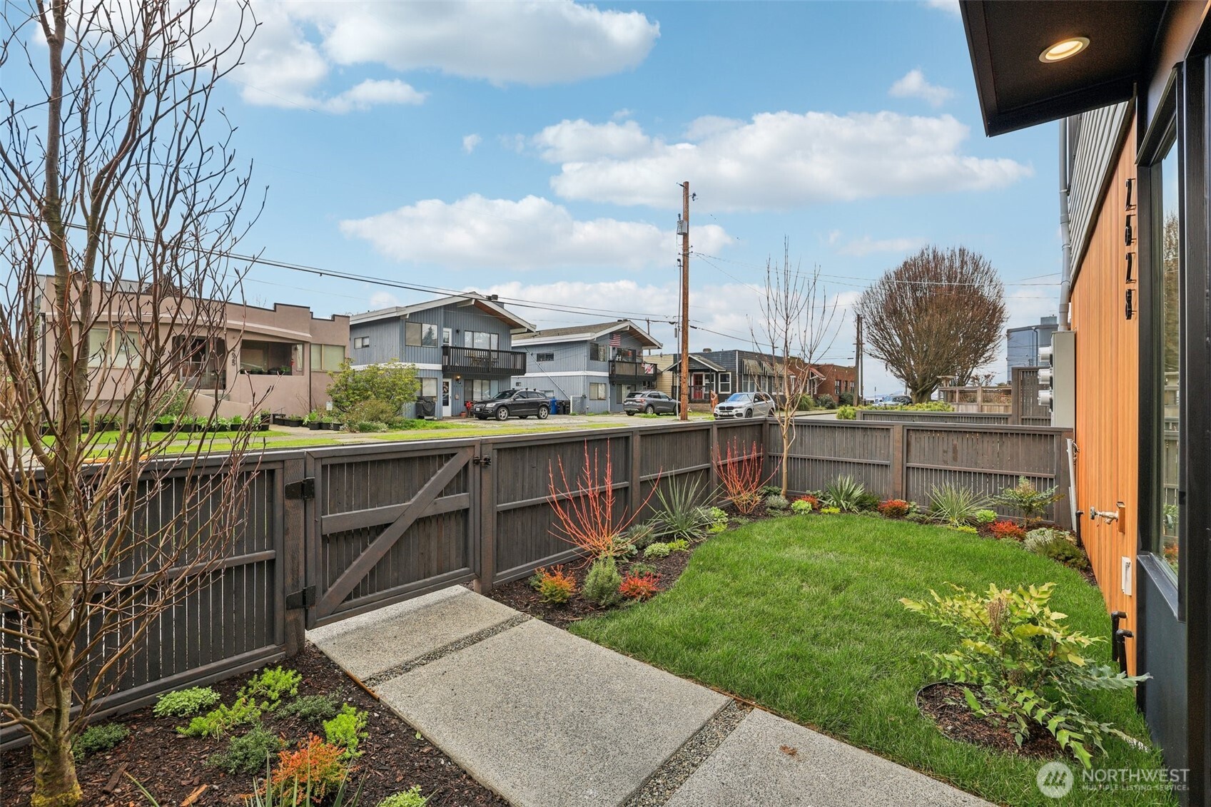 2628 58th Avenue Southwest Seattle, WA 98116 - Photo 3 of 38 a view of a garden with a wooden fence
