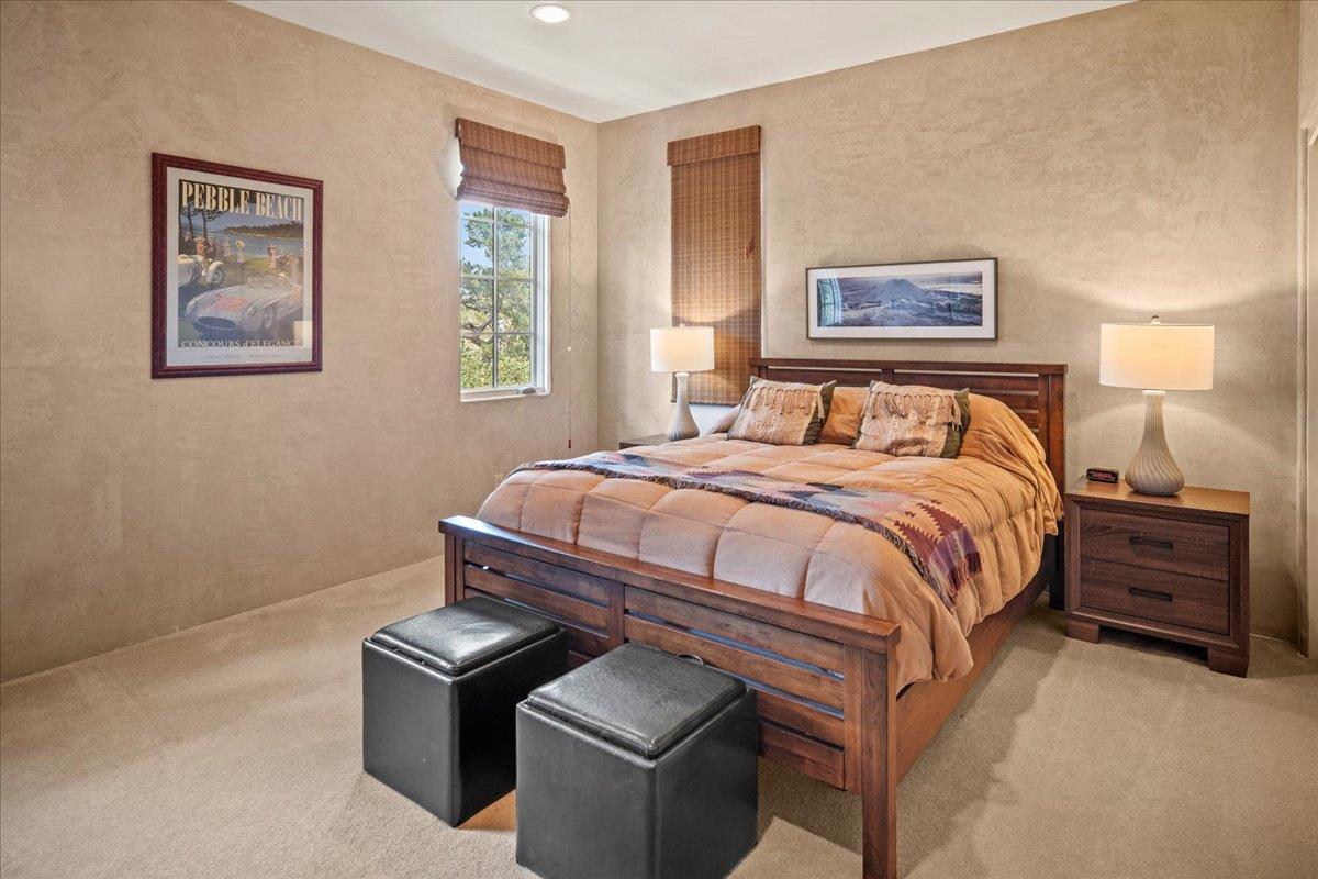 2970 Congress Road Pebble Beach, CA 93953 - Photo 28 of 37 a bedroom with a bed and a lamp on dresser