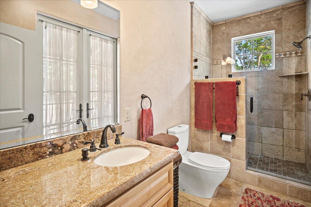 2970 Congress Road Pebble Beach, CA 93953 - Photo 30 of 37 a bathroom with a granite countertop sink toilet and shower