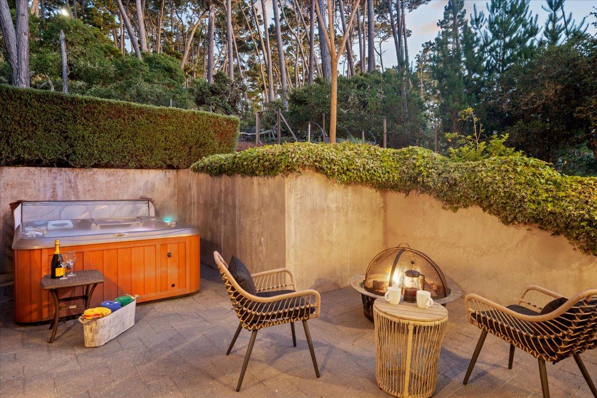 2970 Congress Road Pebble Beach, CA 93953 - Photo 34 of 37 a view of a chairs and table in the back yard of the house