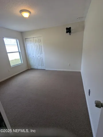 an empty room with windows and entrance