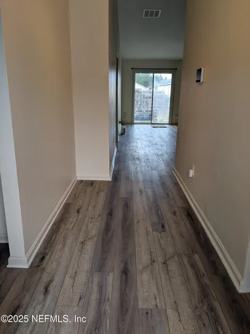 a view of hallway with wooden floor