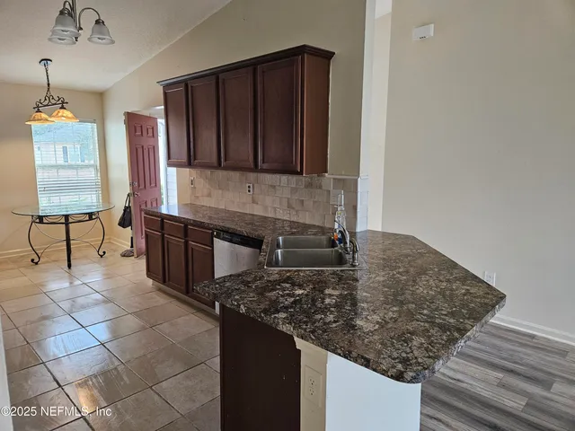 a kitchen with stainless steel appliances granite countertop a sink and a stove