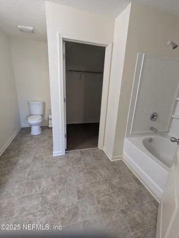 a bathroom with a bathtub sink and toilet