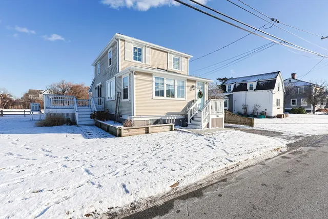 a view of a house with snow on the road