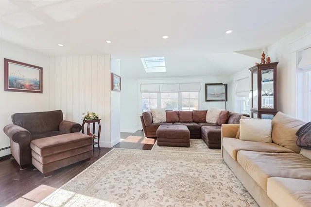 a living room with furniture wooden floor and a rug