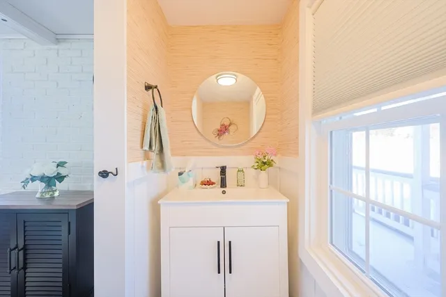 a bathroom with a sink vanity and a mirror