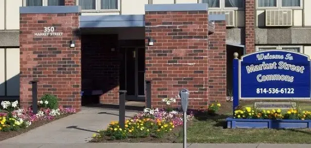 a front view of a building with a garden