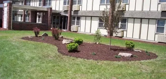 a view of a house with a garden and pathway