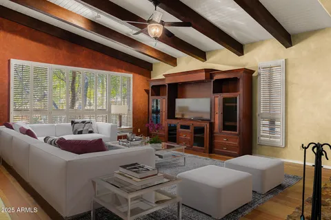 a living room with fireplace furniture and a flat screen tv