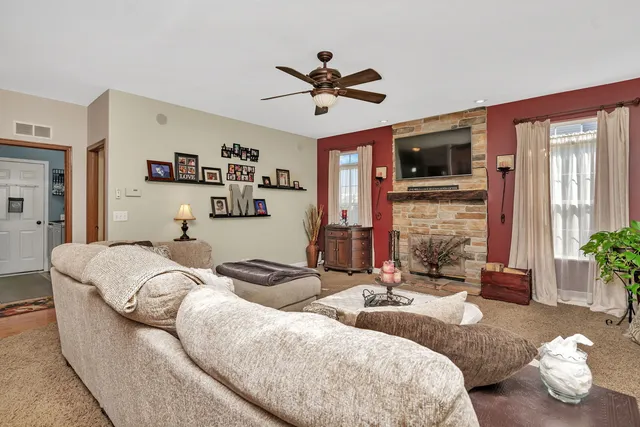 a living room with furniture chandelier and a window