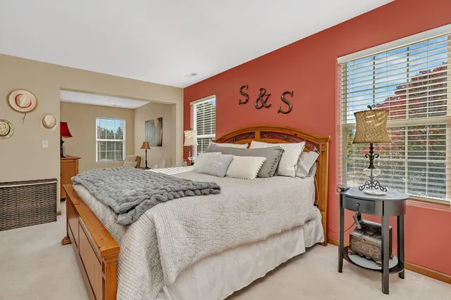 a bedroom with a large bed and a window